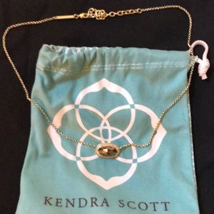 Kendra Scott gold necklace with dark stone